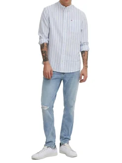 Jeans slim con effetto strappi in denim chiaro
